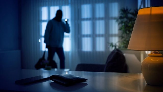 burglar prowling through dark home