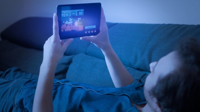 Man watching streaming service on tablet