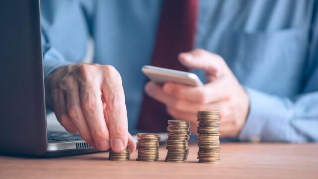 man counting coins budgeting