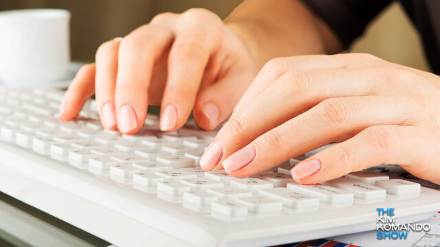 woman's hands typing on a keyboard