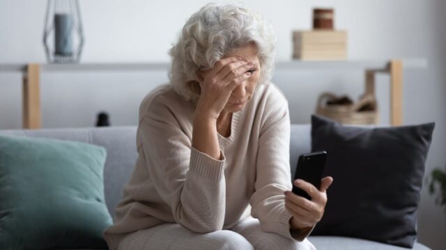 unhappy middle-aged woman getting bad news on phone