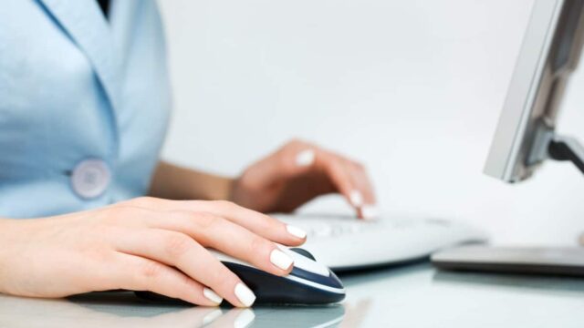 woman using computer mouse