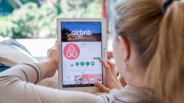 woman browsing airbnb on tablet