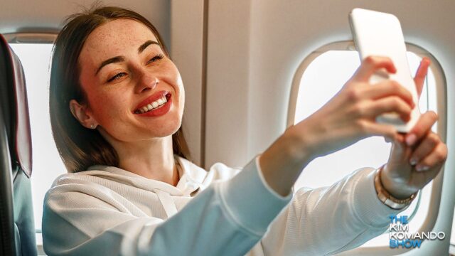 woman taking a selfie on an airplane